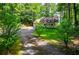 Inviting home with a front porch, attached garage, long driveway, and beautiful landscaping at 9018 Lakeview Pkwy, Villa Rica, GA 30180