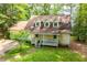 Charming yellow home with a welcoming front porch, surrounded by lush greenery at 9018 Lakeview Pkwy, Villa Rica, GA 30180