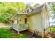 Charming home with a covered porch, lush greenery, and beautiful lake views at 9018 Lakeview Pkwy, Villa Rica, GA 30180