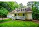 Inviting yellow home with a welcoming front porch, and well manicured lawn at 9018 Lakeview Pkwy, Villa Rica, GA 30180