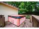 Cozy hot tub on a wood deck surrounded by a lush, wooded backyard at 9018 Lakeview Pkwy, Villa Rica, GA 30180