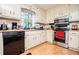Bright kitchen features white cabinets and black appliances with a large window view at 9018 Lakeview Pkwy, Villa Rica, GA 30180