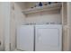 Well-lit laundry room featuring new appliances and a storage shelf at 9018 Lakeview Pkwy, Villa Rica, GA 30180