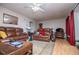 Spacious living room with leather sofas, ceiling fan, and bright window views at 9018 Lakeview Pkwy, Villa Rica, GA 30180