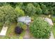 Aerial view showcasing the home's placement on a large lot with mature trees and landscaping at 1140 Reading Nw Dr, Acworth, GA 30102