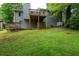 The backyard showcases a deck, stairs and lush greenery, offering a private outdoor space at 1140 Reading Nw Dr, Acworth, GA 30102