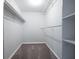 Walk-in closet featuring multiple shelves and hanging rods for storage at 1140 Reading Nw Dr, Acworth, GA 30102