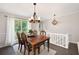 Dining room with a wood table set on a rug and hardwood flooring at 1140 Reading Nw Dr, Acworth, GA 30102