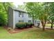 A charming home featuring well-maintained landscaping and mature trees providing ample shade at 1140 Reading Nw Dr, Acworth, GA 30102