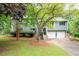 Charming home with a two-car garage, mature trees, and a well-maintained front lawn at 1140 Reading Nw Dr, Acworth, GA 30102