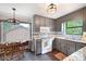 Eat-in kitchen with stone countertops, stainless appliances, and gray cabinets at 1140 Reading Nw Dr, Acworth, GA 30102