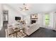 Open concept living room with stone fireplace, ceiling fan and bright light at 1140 Reading Nw Dr, Acworth, GA 30102