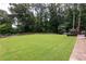 Extensive backyard with a lush lawn, and mature trees at 1908 Musket Ct, Stone Mountain, GA 30087