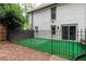 Enclosed backyard with decorative metal fencing, a small area of artificial turf, and access to the house at 1908 Musket Ct, Stone Mountain, GA 30087