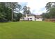 Spacious backyard featuring a lush lawn, trampoline, and fenced border, ideal for outdoor enjoyment at 1908 Musket Ct, Stone Mountain, GA 30087