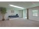 Cozy finished basement featuring a daybed, sliding door, and large window, providing ample natural light at 1908 Musket Ct, Stone Mountain, GA 30087