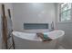 Freestanding tub with wooden ladder and accent tiles at 1908 Musket Ct, Stone Mountain, GA 30087