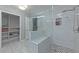 Modern bathroom featuring a spacious glass shower with a seat and decorative pebble flooring at 1908 Musket Ct, Stone Mountain, GA 30087