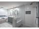 Bright bathroom featuring double vanity, soaking tub, and glass-enclosed shower with seat and textured white tile at 1908 Musket Ct, Stone Mountain, GA 30087
