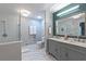 Elegant bathroom with a double sink vanity, marble floors, and a glass-enclosed shower at 1908 Musket Ct, Stone Mountain, GA 30087