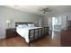 Bedroom featuring hardwood floors, a ceiling fan, and an ensuite bathroom at 1908 Musket Ct, Stone Mountain, GA 30087