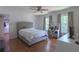 Comfortable bedroom with hardwood floors, two windows, desk and chair, and a walk-in closet at 1908 Musket Ct, Stone Mountain, GA 30087