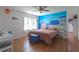 Well-lit bedroom boasts beautiful hardwood floors, vibrant mural and an adjoining walk-in closet at 1908 Musket Ct, Stone Mountain, GA 30087