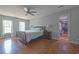 Bedroom featuring wood floors, windows and a walk-in closet at 1908 Musket Ct, Stone Mountain, GA 30087