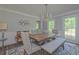 Dining room featuring a wooden table, stylish chairs, and a bench, illuminated by a chandelier at 1908 Musket Ct, Stone Mountain, GA 30087