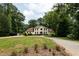 Expansive home with sprawling lawn, mature trees, and a long driveway leading to the grand facade at 1908 Musket Ct, Stone Mountain, GA 30087