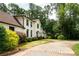 A winding brick driveway leads to a beautiful home with manicured landscaping, creating a welcoming ambiance at 1908 Musket Ct, Stone Mountain, GA 30087