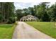 A view of the home from the long driveway showcases the architecture and spacious front yard at 1908 Musket Ct, Stone Mountain, GA 30087