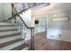 Inviting foyer features a staircase with wrought iron railing and new hardwood floors throughout at 1908 Musket Ct, Stone Mountain, GA 30087