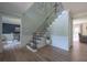 Inviting foyer featuring elegant staircase, chandelier, and wood flooring, seamlessly connecting living spaces at 1908 Musket Ct, Stone Mountain, GA 30087