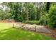 Garden beds, framed by a picket fence, surrounded by a lush green lawn and mature trees at 1908 Musket Ct, Stone Mountain, GA 30087