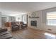 Open-concept living space with a fireplace, modern furniture, and lots of natural light at 1908 Musket Ct, Stone Mountain, GA 30087