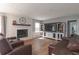 Comfortable living room with fireplace, entertainment center and hardwood floors at 1908 Musket Ct, Stone Mountain, GA 30087