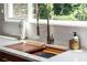 Close up on the sink and countertop with a wooded cutting board attached to the sink at 1908 Musket Ct, Stone Mountain, GA 30087