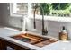 Close up on the sink and countertop with a wooded cutting board attached to the sink at 1908 Musket Ct, Stone Mountain, GA 30087