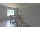 Staircase with wood railing and chandelier at 1908 Musket Ct, Stone Mountain, GA 30087