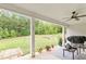 Charming backyard featuring a covered patio, a fire pit, a lush lawn and a treelined perimeter at 2241 N 16 Hwy, Whitesburg, GA 30185