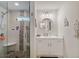 Modern bathroom featuring a walk-in shower with river rock floor and vanity with round mirror at 2241 N 16 Hwy, Whitesburg, GA 30185