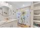 Bright bathroom featuring a single sink vanity with storage and a decorative shower curtain with a sunflower design at 2241 N 16 Hwy, Whitesburg, GA 30185