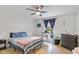 This is a comfortable bedroom featuring a bed, a dresser and a desk area with natural light from the window at 2241 N 16 Hwy, Whitesburg, GA 30185