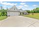 Single-Gathering home boasting a long concrete driveway leading to an attached two-car garage at 2241 N 16 Hwy, Whitesburg, GA 30185