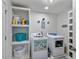 Functional laundry room with washer, dryer, and built-in shelving for storage at 2241 N 16 Hwy, Whitesburg, GA 30185