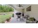 Outdoor patio featuring stylish seating arrangements, a ceiling fan, and beautiful views of the surrounding greenery at 2241 N 16 Hwy, Whitesburg, GA 30185