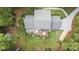 Aerial view of the house highlighting the deck, backyard, driveway, and mature trees surrounding the home at 260 Waverly Hall Dr, Roswell, GA 30075