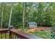A view from the deck featuring an outdoor shed, green grass, and a wooden fence at 260 Waverly Hall Dr, Roswell, GA 30075