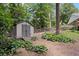 Backyard shed provides extra storage space, blending seamlessly into the lush landscaping of this well-maintained property at 260 Waverly Hall Dr, Roswell, GA 30075